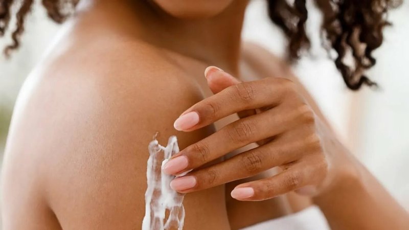 Girl applies the cream to the body