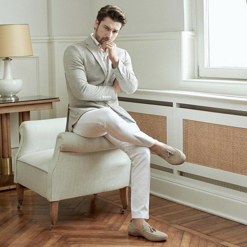 Burak Ozchitivit in a white suit