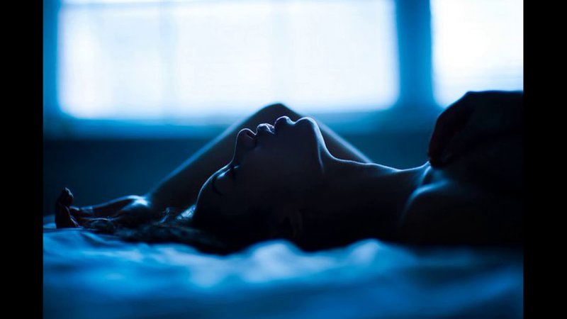 The girl lies in the dark