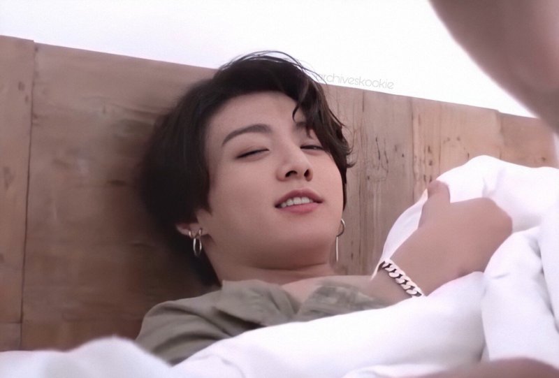 Jungkook lies on the bed