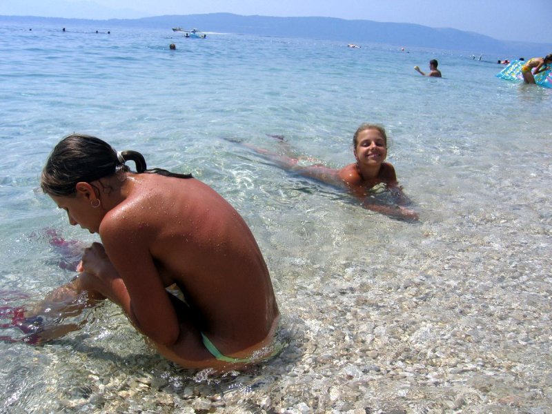 Nudists on the beach with children