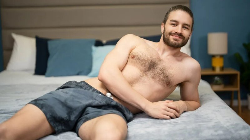 A man with a beard lies