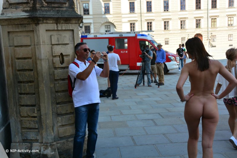 Naked woman among dressed